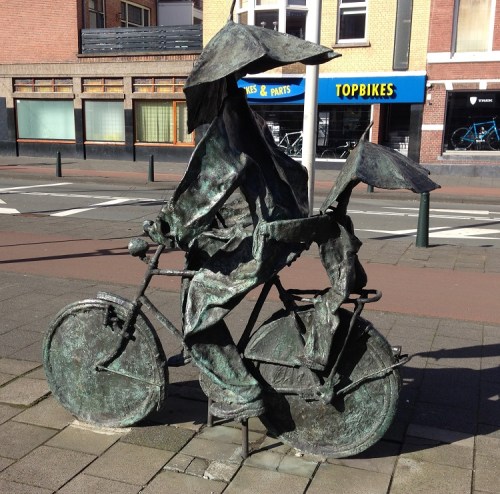 Dutch metal sculpture of bikers with umbrellas